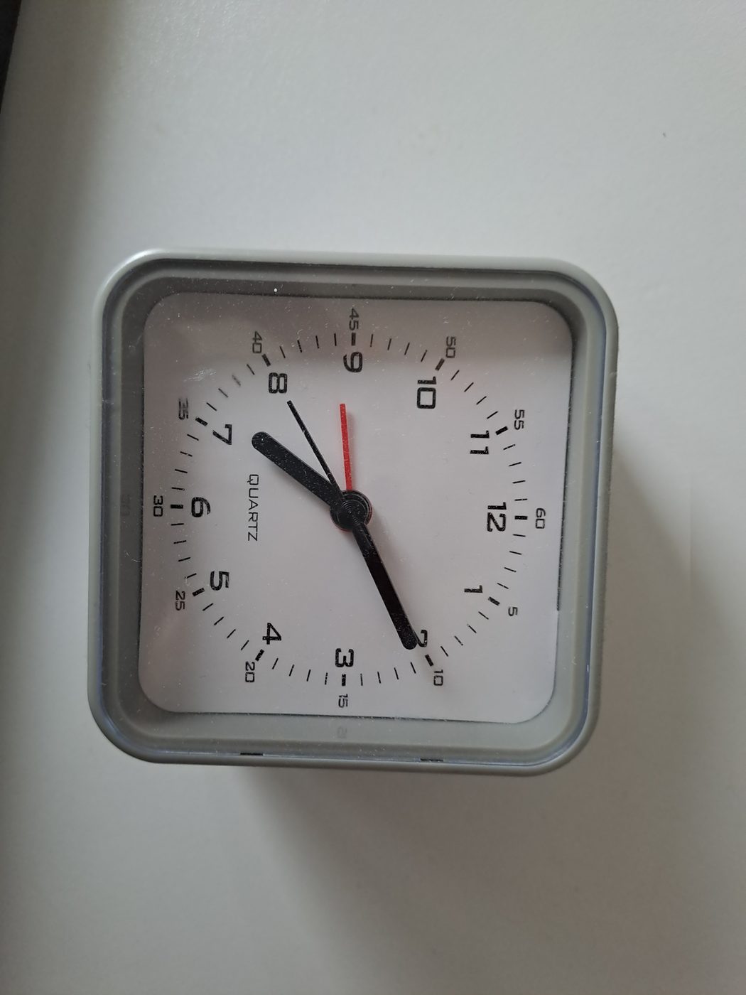 A simple square analog alarm clock