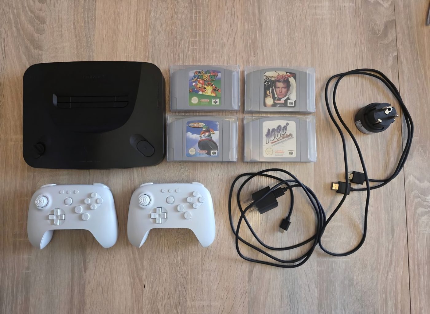 The Analogue 3D console with two 8BitDo controllers and Nintendo 64 cartridges