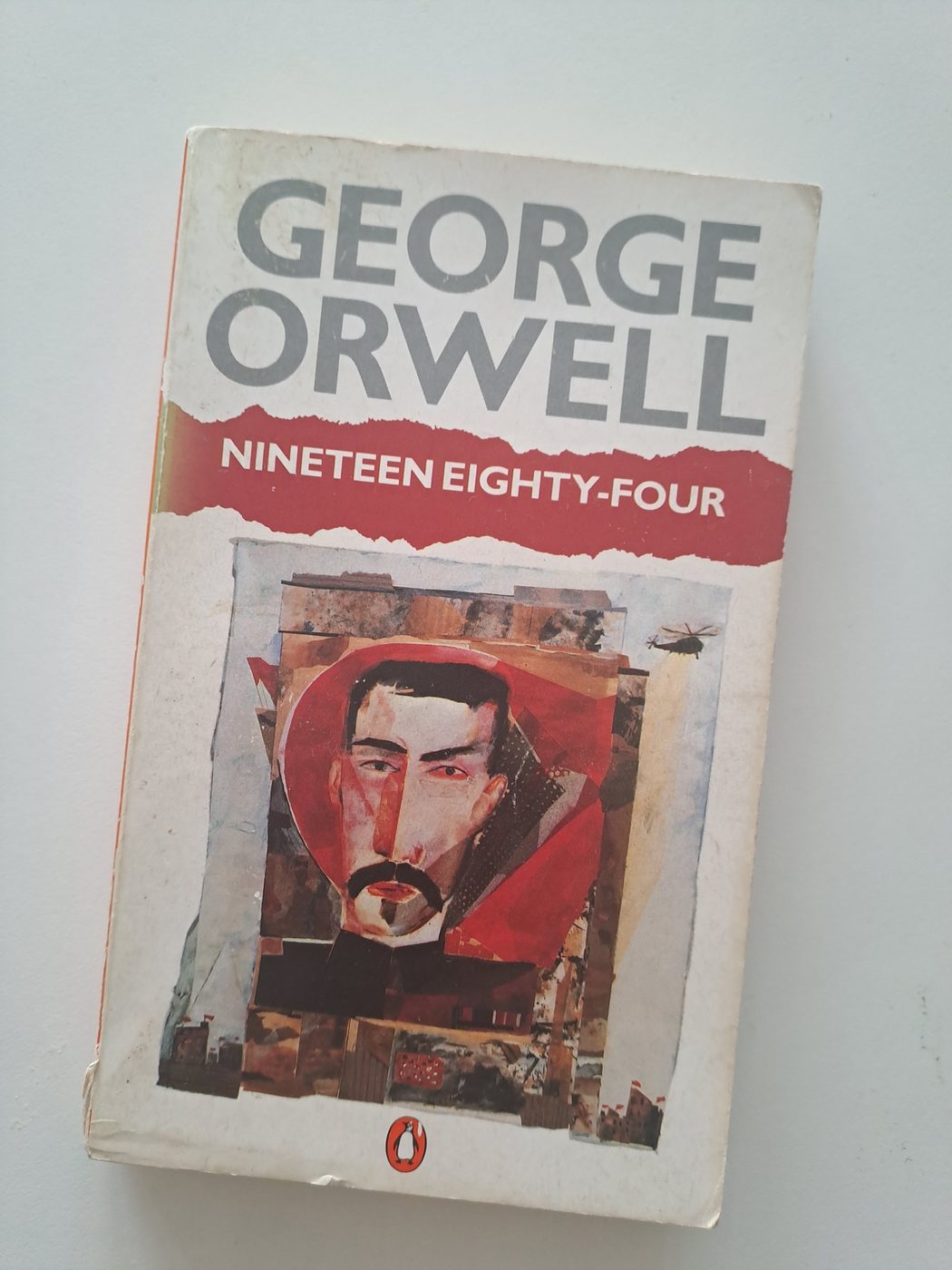A well-read paperback of Nineteen Eighty-Four by George Orwell