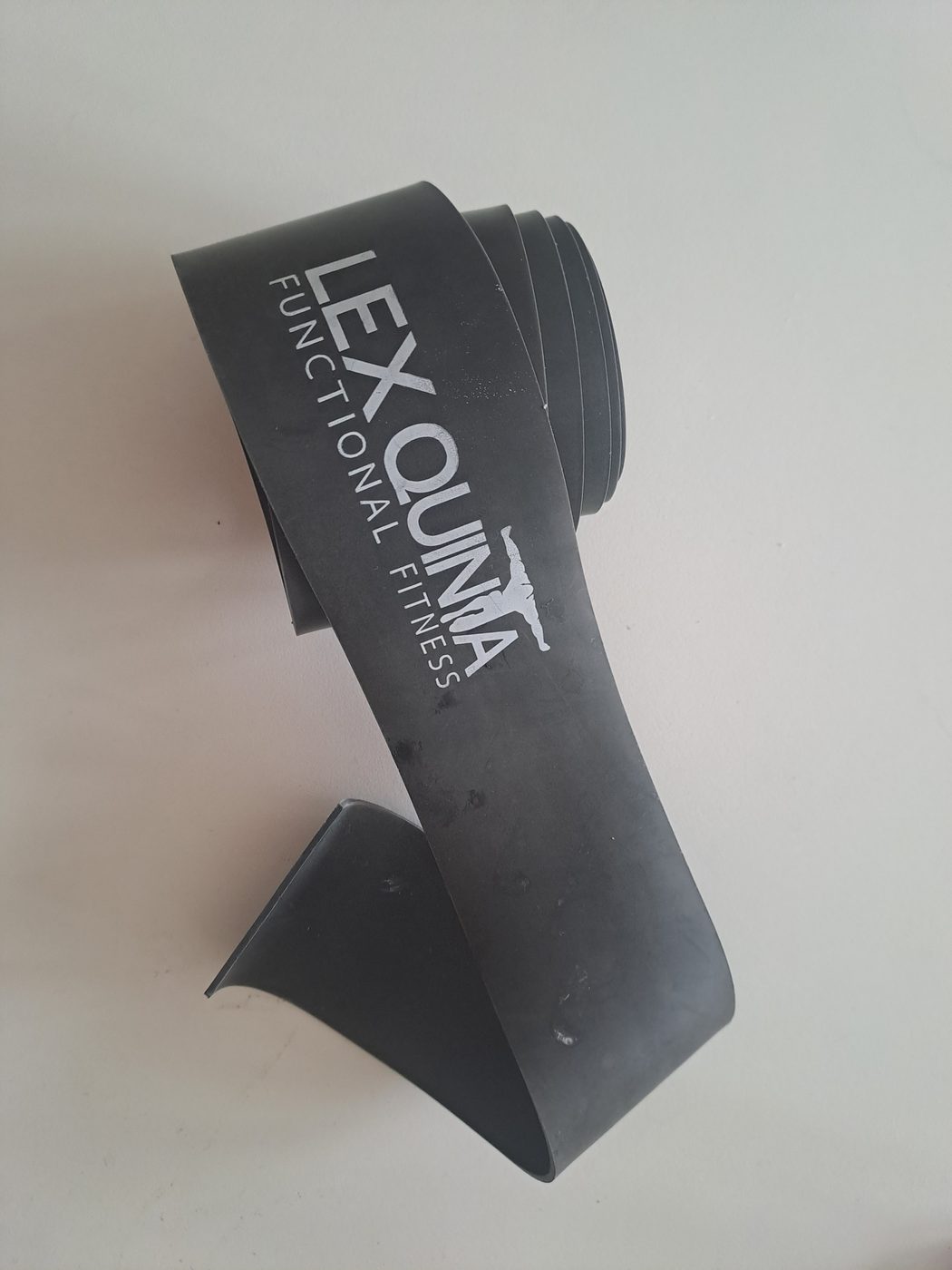 A black rubber flossing band rolled up